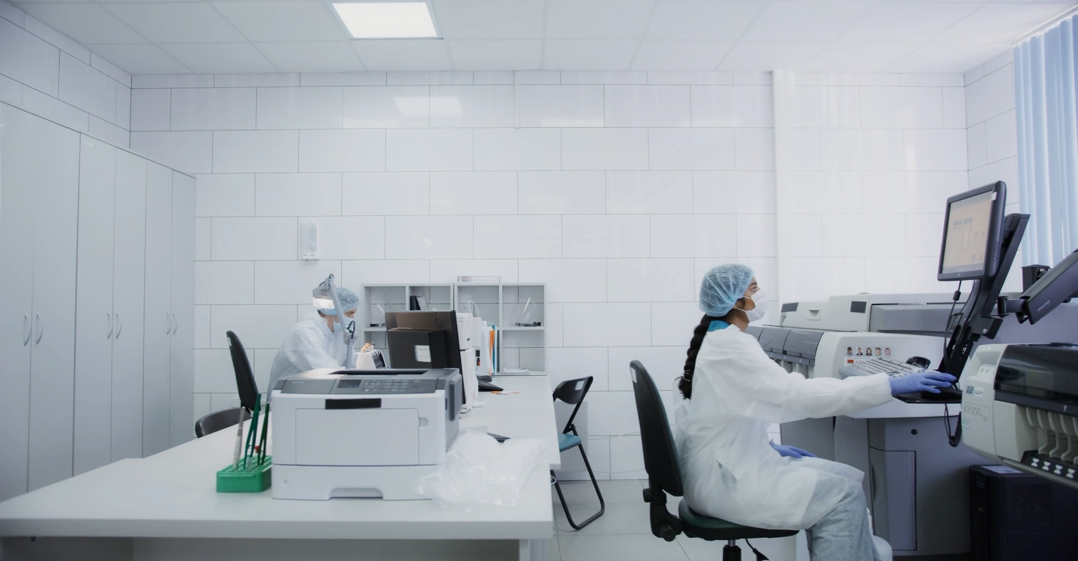 Laboratory professionals working with diagnostic testing equipment